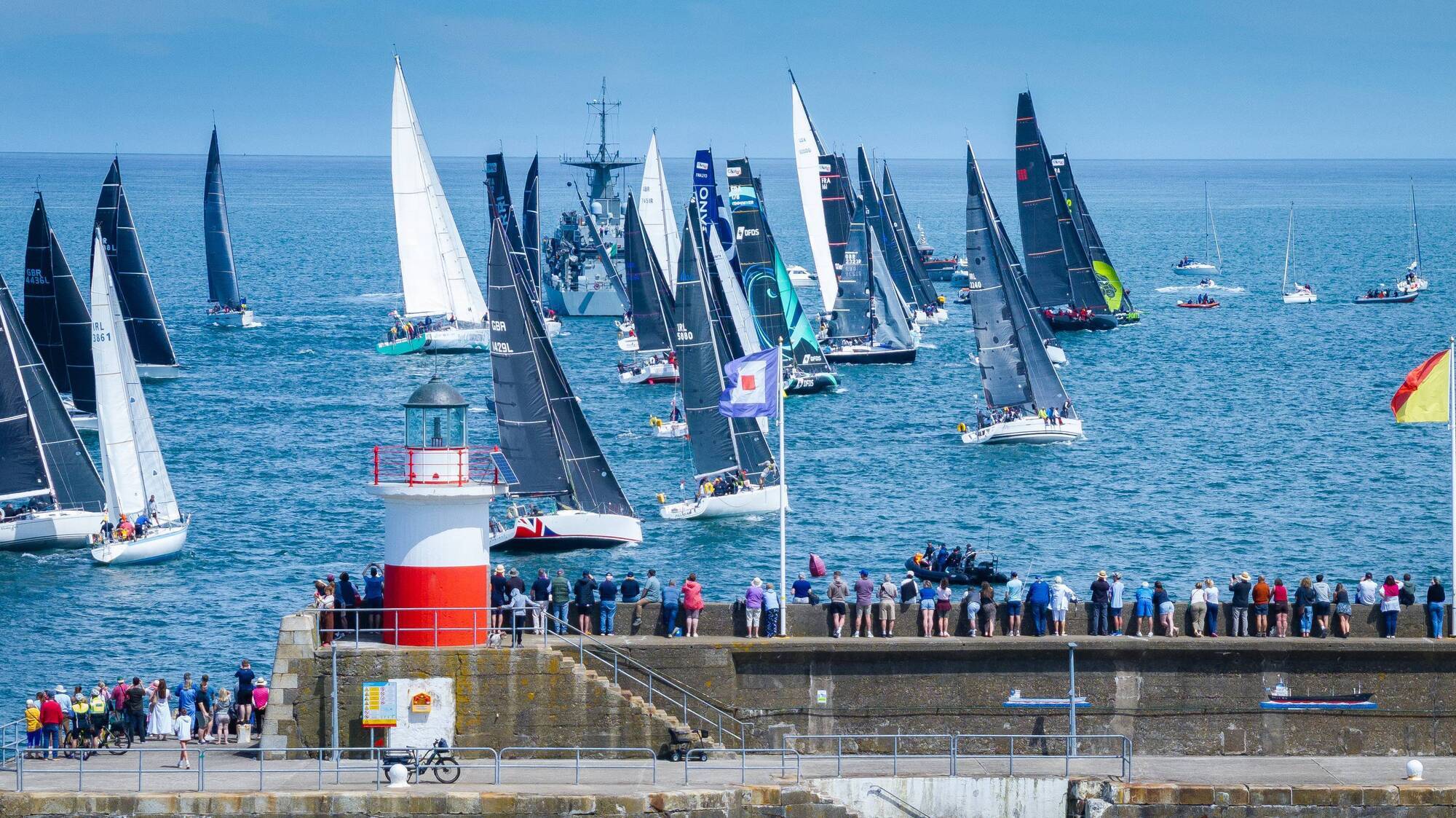 Crowds line the pier and shoreline for the start of the 704 nautical-mile Round Ireland Race where 53 boats from Ireland overseas gathered for the contest that could last up to six days. Pic: David Branigan/Oceansport Repro
