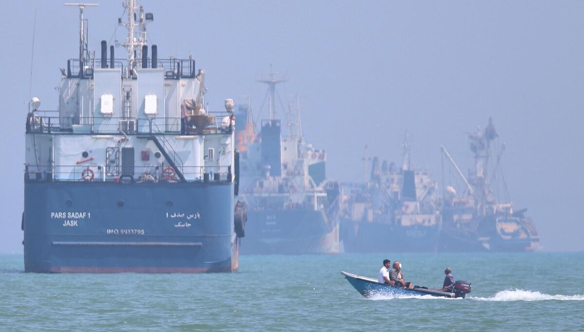 A small motorboat passes anchored vessels in the Strait of Hormuz off Bandar Abbas, Iran. Picture: Amirhosein Khorgooi/ISNA via AP