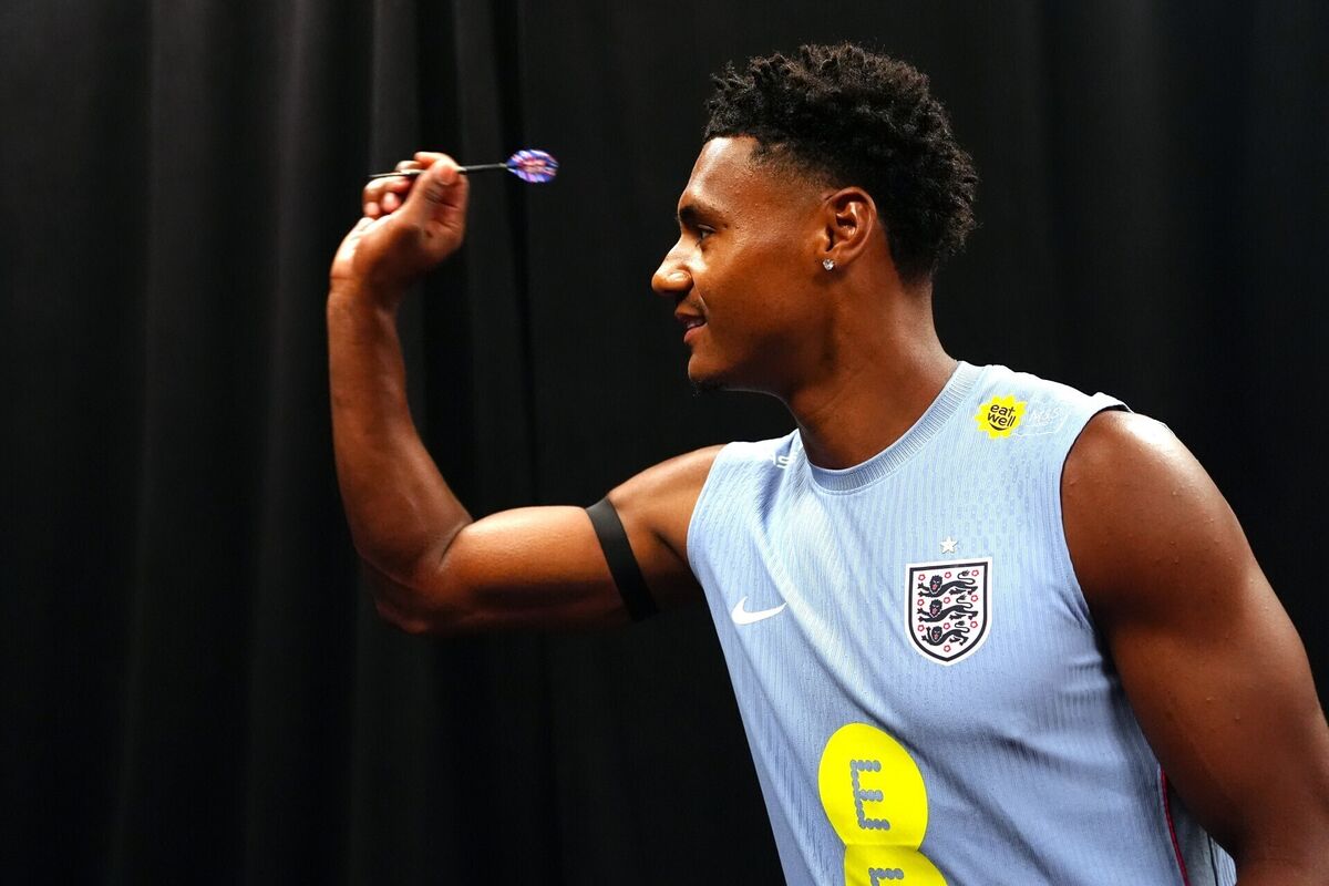 BULLSEYE: England's Ollie Watkins plays darts during a press conference at Swope Soccer Village, Kansas City. Picture: Bradley Collyer/PA BULLSEYE: England's Ollie Watkins plays darts during a press conference at Swope Soccer Village, Kansas City. Picture: Bradley Collyer/PA