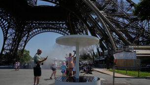 People cool off in a water spray near the Eiffel Tower in Paris (Michel Euler/AP) People cool off in a water spray near the Eiffel Tower in Paris (Michel Euler/AP)