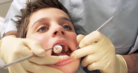 Close-up of boy having teeth examined