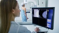 medical technician taking mammogram exam to female patient. Mature woman undergoing breast screening or mammography