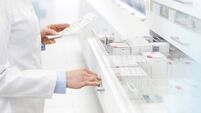 Pharmacist filling prescription in pharmacy