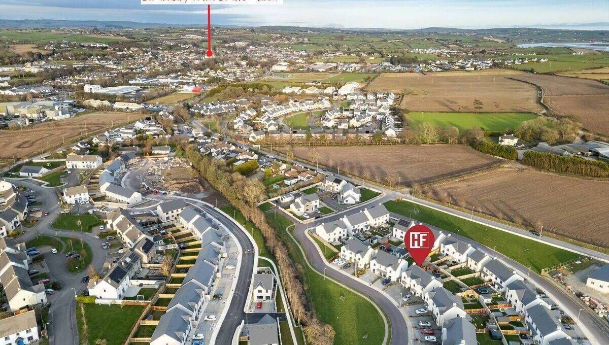 Homes at The Miles, left, and Sruthán Beag. The new site is across the road beyond the farm house and yard/buildings. 