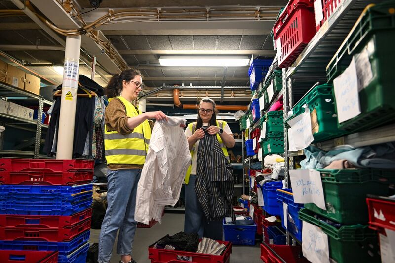 Volunteers sort donated clothing at The Lighthouse Café. Volunteers sort donated clothing at The Lighthouse Café.