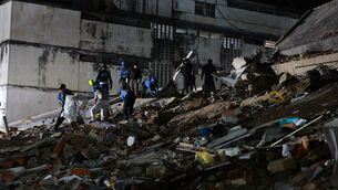 <p>Rescue workers search through the rubble of a collapsed building after an earthquake in Caracas(Javier Campos/AP)</p>