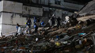 <p>Rescue workers search through the rubble of a collapsed building after an earthquake in Caracas(Javier Campos/AP)</p>