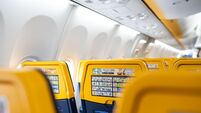 Ryanair empty seats with safety instruction. Airplane interior view. No people, selective focus. Ryanair is an Irish low-cost ai
