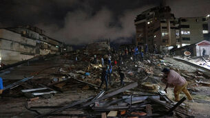 <p>Rescue workers search through the rubble in Caracas (Javier Campos/AP)</p>