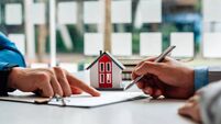 Customers interested in buying a home sign a signature to enter into a home purchase contract with a real estate agent. Mortgage