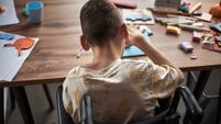 Child with Disability Engaged in Arts and Crafts Activity Sitting in Wheelchair