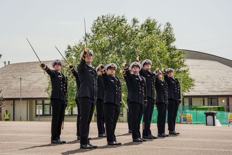 Newly commissioned naval officers raise their swords during the commissioning ceremony at the naval base on Haulbowline Island on Thursday. Picture: Noel Sweeney