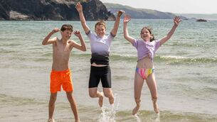 <p>Shane McCarthy and Colm and Ella Moynihan, all from Ballingeary, Co Cork, splashing about in Rosscarbery, West Cork as people headed for the beach on a scorching hot day. Picture: Andy Gibson</p>