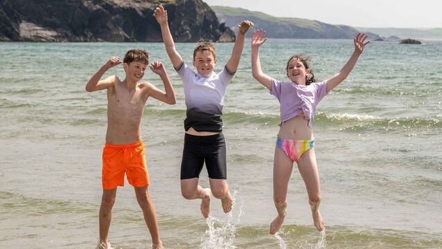 <p>Shane McCarthy and Colm and Ella Moynihan, all from Ballingeary, Co Cork, splashing about in Rosscarbery, West Cork as people headed for the beach on a scorching hot day. Picture: Andy Gibson</p>