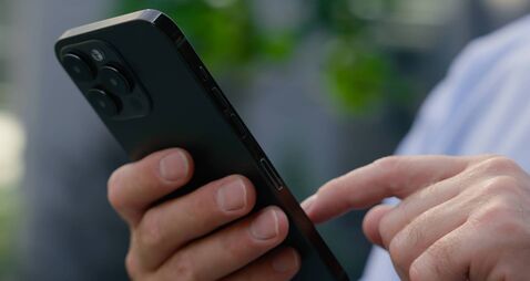 Close up Caucasian male hands arms holding mobile phone scrolling screen social media app unrecognizable man unknown businessman