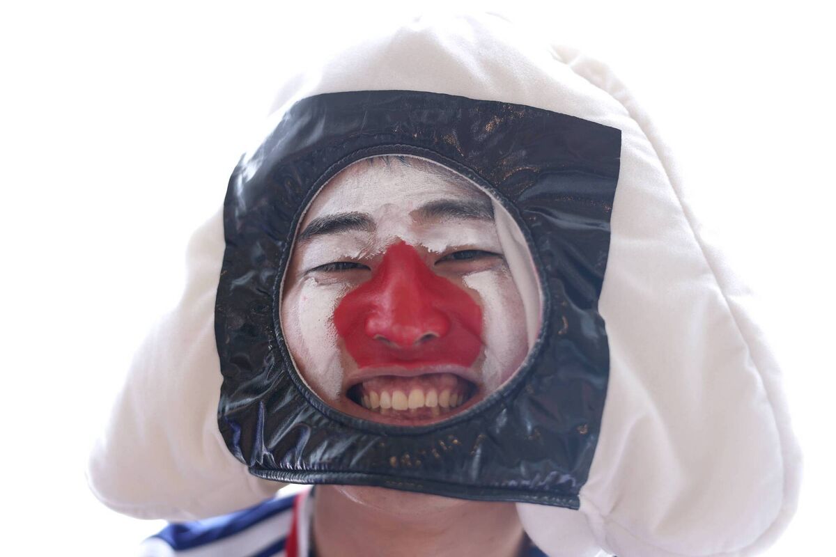 A fan of Japan poses for photographs in Arlington, Texas in rain gear before his country's meeting with Sweden. Picture: Lars Baron/Getty A fan of Japan poses for photographs in Arlington, Texas in rain gear before his country's meeting with Sweden. Picture: Lars Baron/Getty