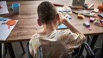 Child with Disability Engaged in Arts and Crafts Activity Sitting in Wheelchair