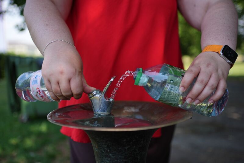 A person fills a water bottle from a drinking fountain in Greenwich Park, London. Picture: Yui Mok/PA Wire