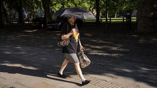 <p>People use brolleys for shade as they make an early morning journey across the centre of Bristol where temperatures are already in the mid 20’s and extremely humid after overnight thunderstorms. Picture: Ben Birchall/PA Wire</p>
