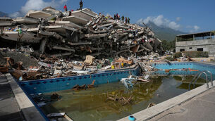 <p>Rescue workers search through the rubble (Fernando Vergara/AP)</p>