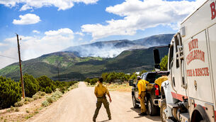 A firefighter watches as the Cottonwood Fire burns near Beaver, Utah (Noah Berger/AP)