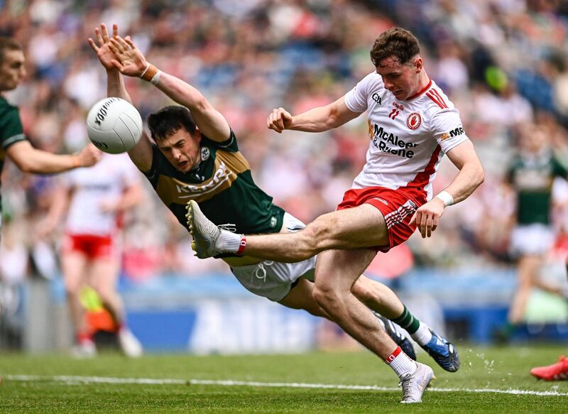 Tyrone's Ronan Cassidy of Tyrone kicks a point despite the best efforts of Kerry's Paul Murphy. Pic: Ben McShane/Sportsfile Tyrone's Ronan Cassidy of Tyrone kicks a point despite the best efforts of Kerry's Paul Murphy. Pic: Ben McShane/Sportsfile