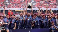 Cameron Woki celebrates with the Champions Cup Trophy and teammates after the match 23/5/2026