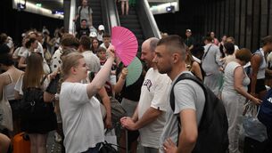 <p>Passengers use hand fans waiting for trains delayed due to the heatwave at Warsaw Central railway station in Warsaw on Sunday. Picture: Sergei Gapon / AFP via Getty Images</p>