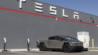 Tesla Cybertruck display at a dealership. Tesla offers the Cybertruck with driving range of up to 334 miles. MY:2025