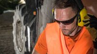 Worker Operates Machinery at Construction Site During Evening Hours