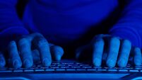 Men's hands and computer keyboard close-up. Blue backlight