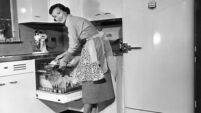 Apron housewife at kitchen dish washer