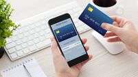 female hands holding phone with mobile wallet for online shoppin
