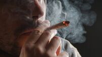 Man smoking a marijuana joint
