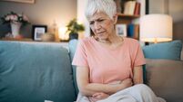 Old female having stomachache