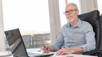 Retirement_iStock-665790700.jpg Portrait of businessman sitting in office, hard light