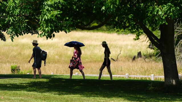 <p>People walk in the shade through Ely Park in Cambridgeshire during the recent heatwave.</p>