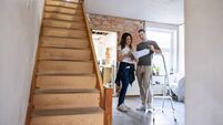 Happy couple looking at sketches while remodeling their house