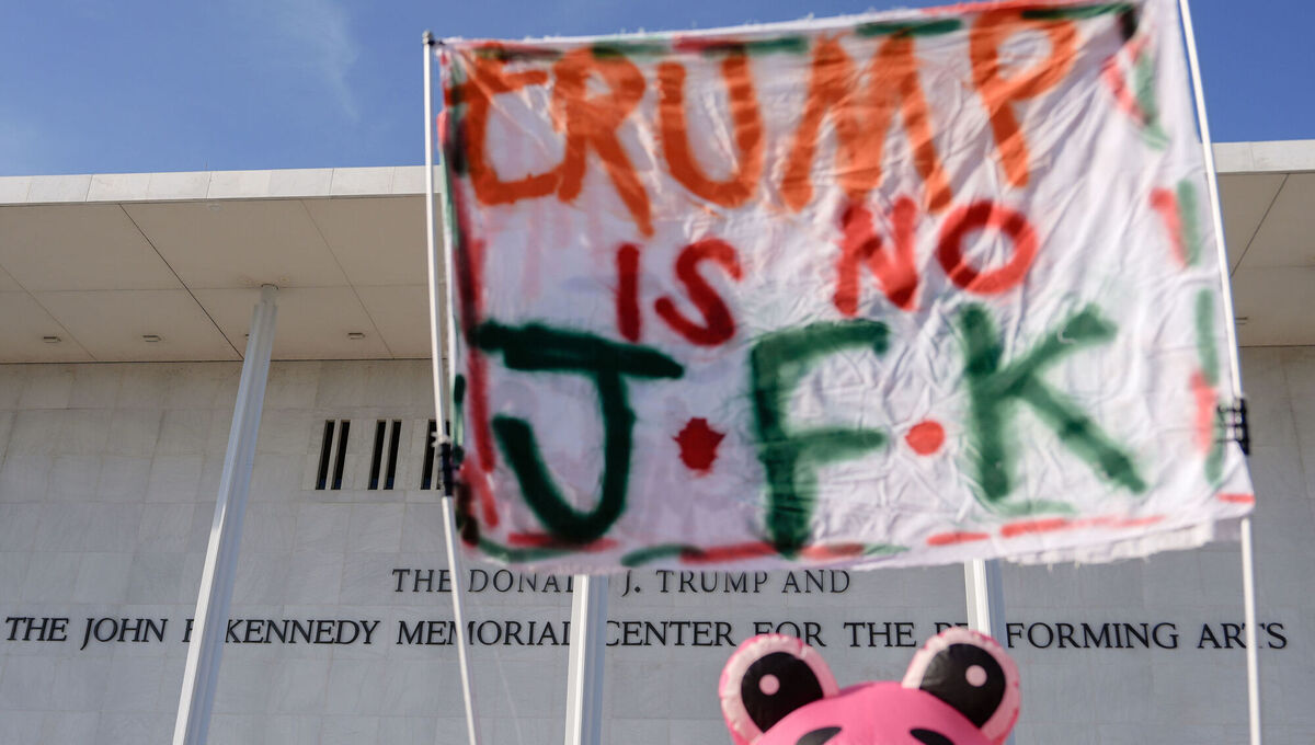 Nadine Siler holds up a sign at a designated protest point in front of the John F Kennedy Memorial Center for the Performing Arts, a day after a Trump-appointed board voted to add president Donald Trump's name to the Kennedy Center in 2025. Picture: Julia Demaree Nikhinson/AP