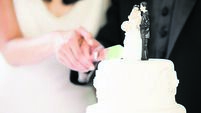 Newlyweds cutting wedding cake