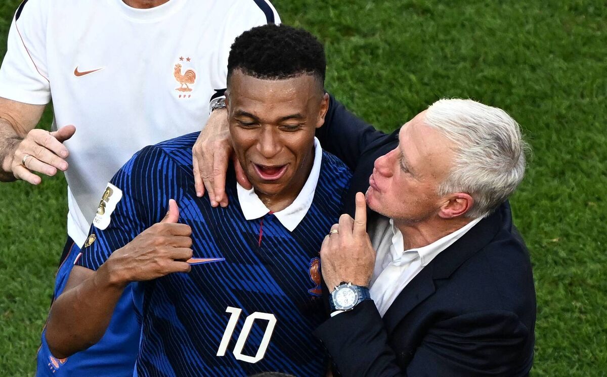 ZIP IT: French head coach Didier Deschamps keeps Kylian Mbappe away from trouble after their tempestuous Round of 16 clash against Paraguay. 