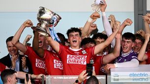 <p>REBEL ROAR: Joe Miskella of Cork lifts the cup. Pic: Sam Barnes/Sportsfile</p>