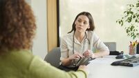 female gp listening to patient