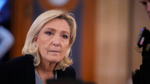 Marine Le Pen walks outside the courtroom during a short break in her appeals trial in Paris earlier this year (Michel Euler/AP)