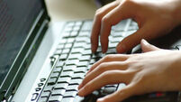 Hands typing on labtop keyboard.