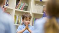 Young School Boy With His Hands Clasped