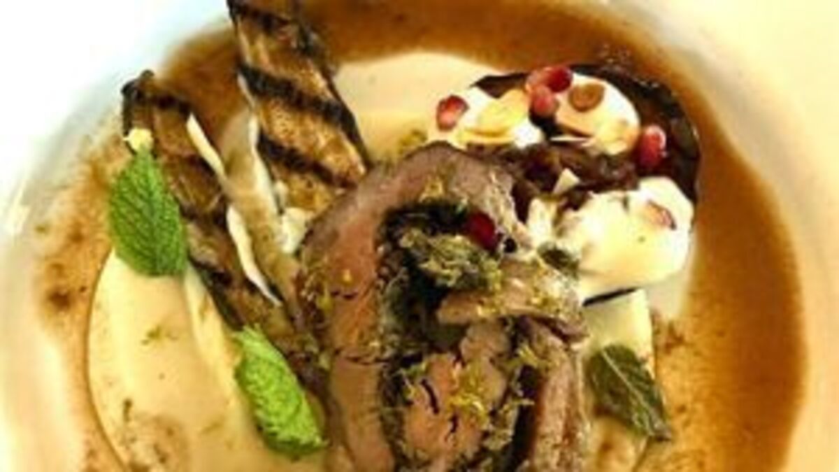 Roast loin of lamb stuffed with walnut and parsley pesto on butter bean mash