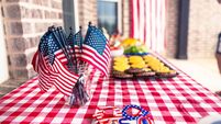 Fourth of July BBQ food spread on picnic table