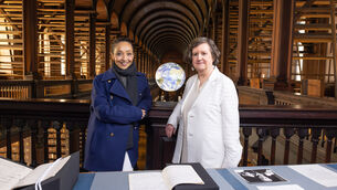 <p>Actor and Trinity graduate Ruth Negga takes a look through the university's library in Trinity's Treasures, Friday. Picture: Paul Sharp/SHARPPIX</p>