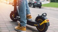 E Scooter .jpg Close up low angle view cropped shot of a man riding electro scooter at the street